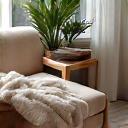Cozy corner of a home with natural fiber throw blankets and cushions, creating a calm ambiance.