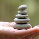 A serene hand holding a smooth, polished stone, symbolizing balance and holistic well-being